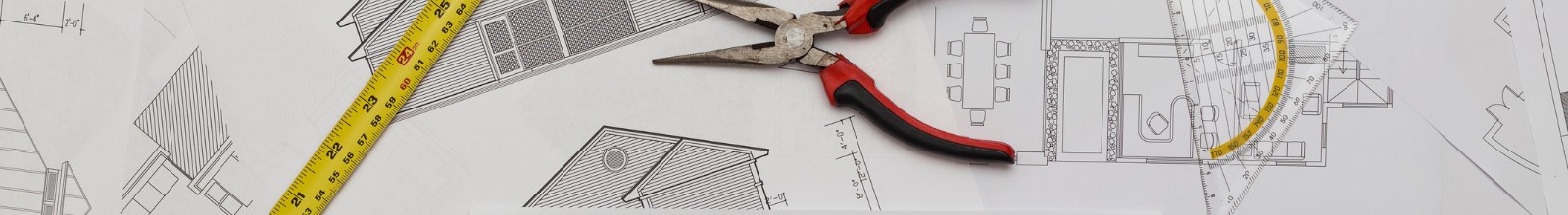 A table with building plans and tools on it