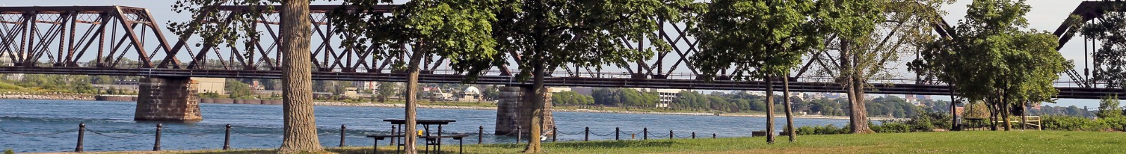 A large river runs along a shoreline park