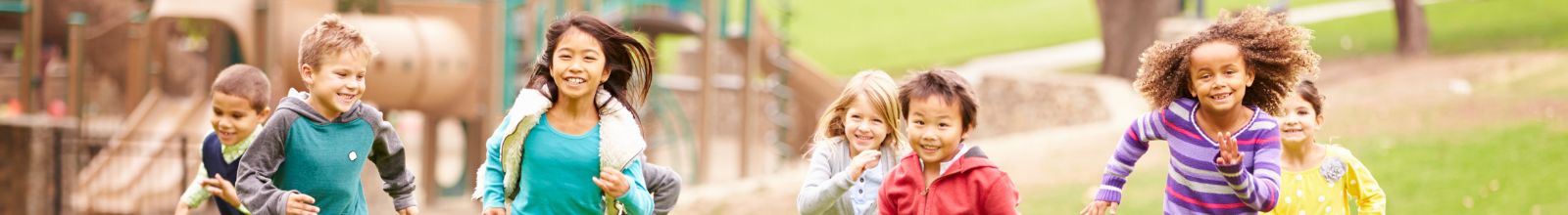 A group of youth run in a park.