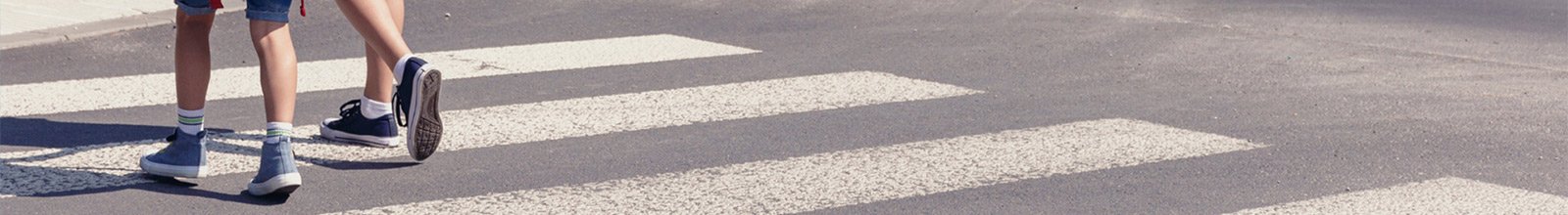 2 children crossing a school crosswalk