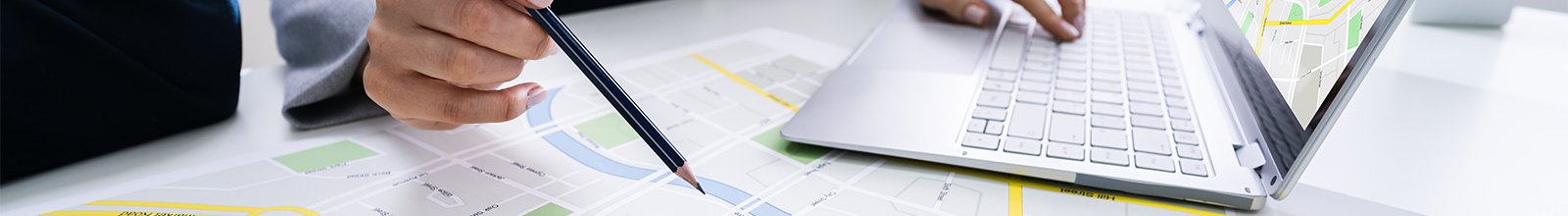 woman with a pencil marking a map