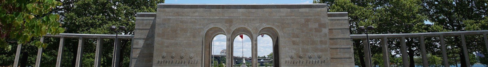 A wide monument with large arches in the summer