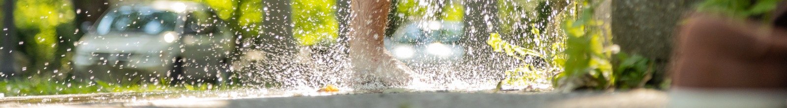 A person washing their feet at the tap