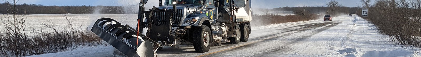 Snow plow clearing a road