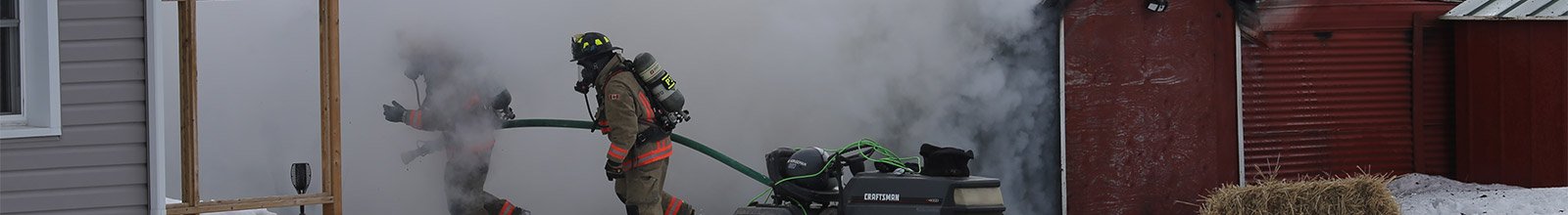 Firefighters entering a burning house