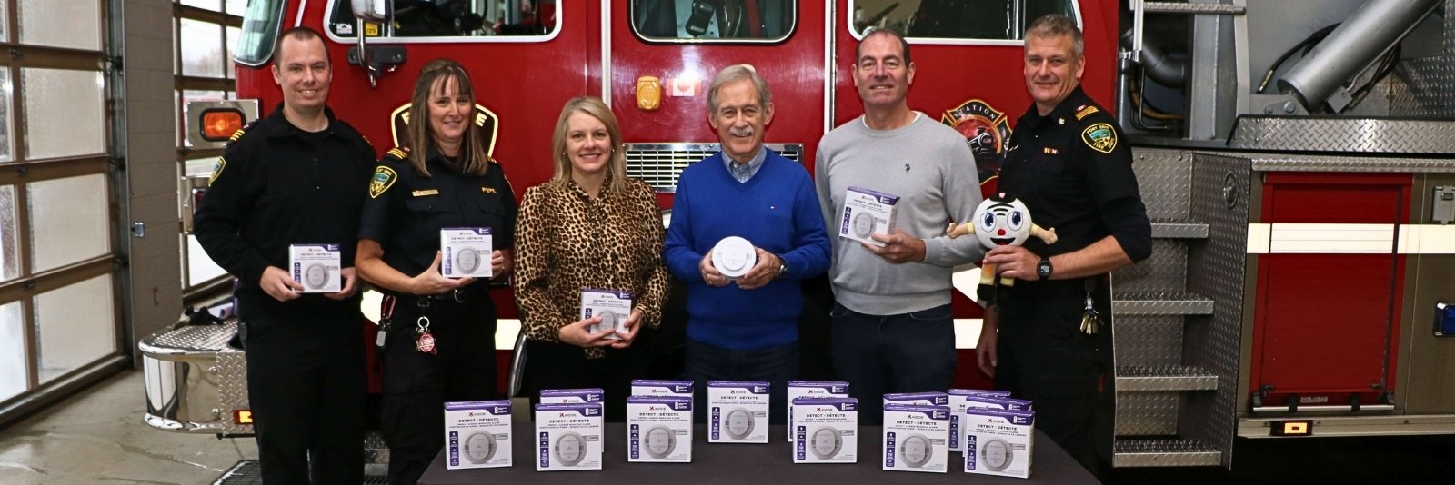 A group stands with Smoke Alarms