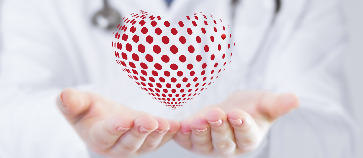 A doctor holding a graphical representation of a heart