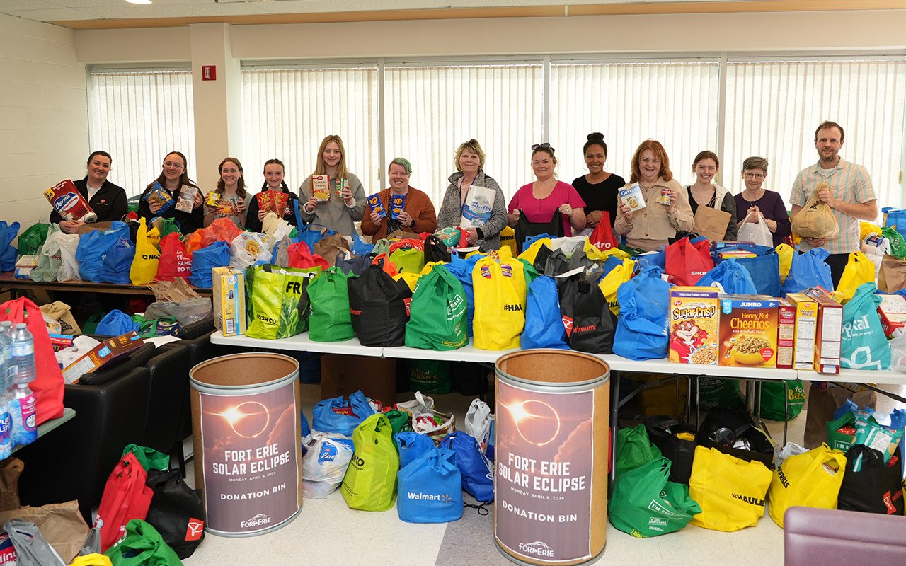 A group of people standing with donations