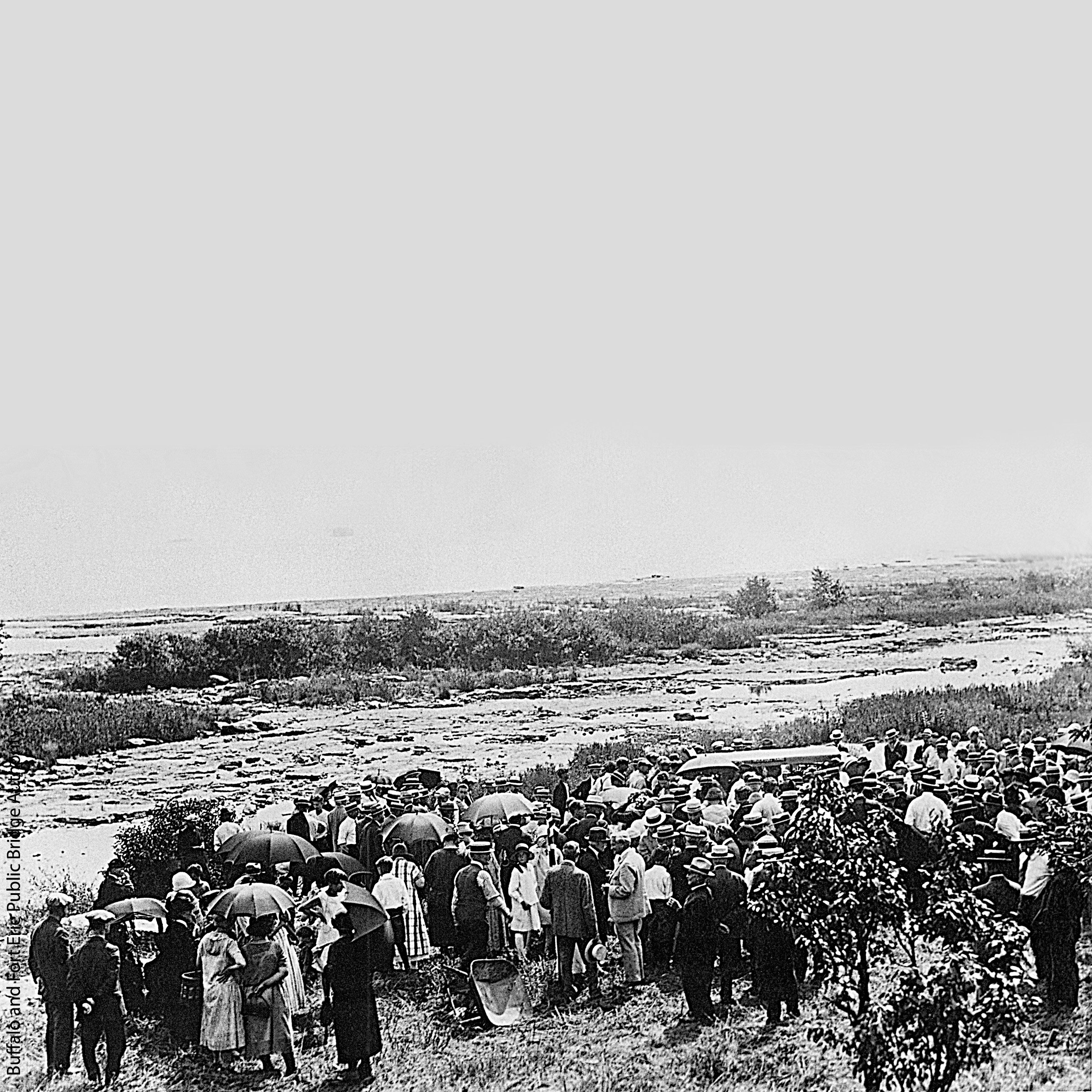 A large group of people stand together for a ground breaking ceremony