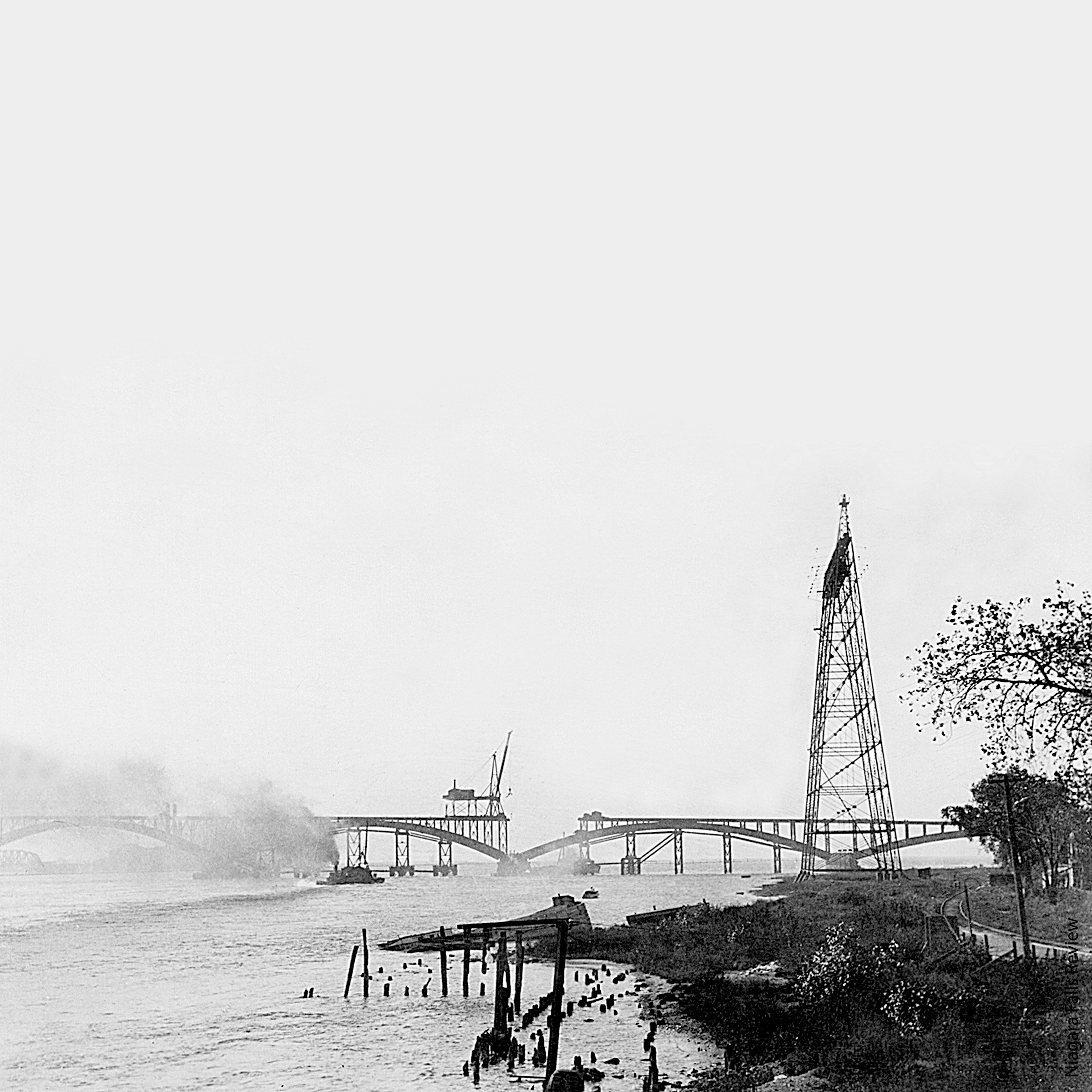 A large bridge under construction over a large river