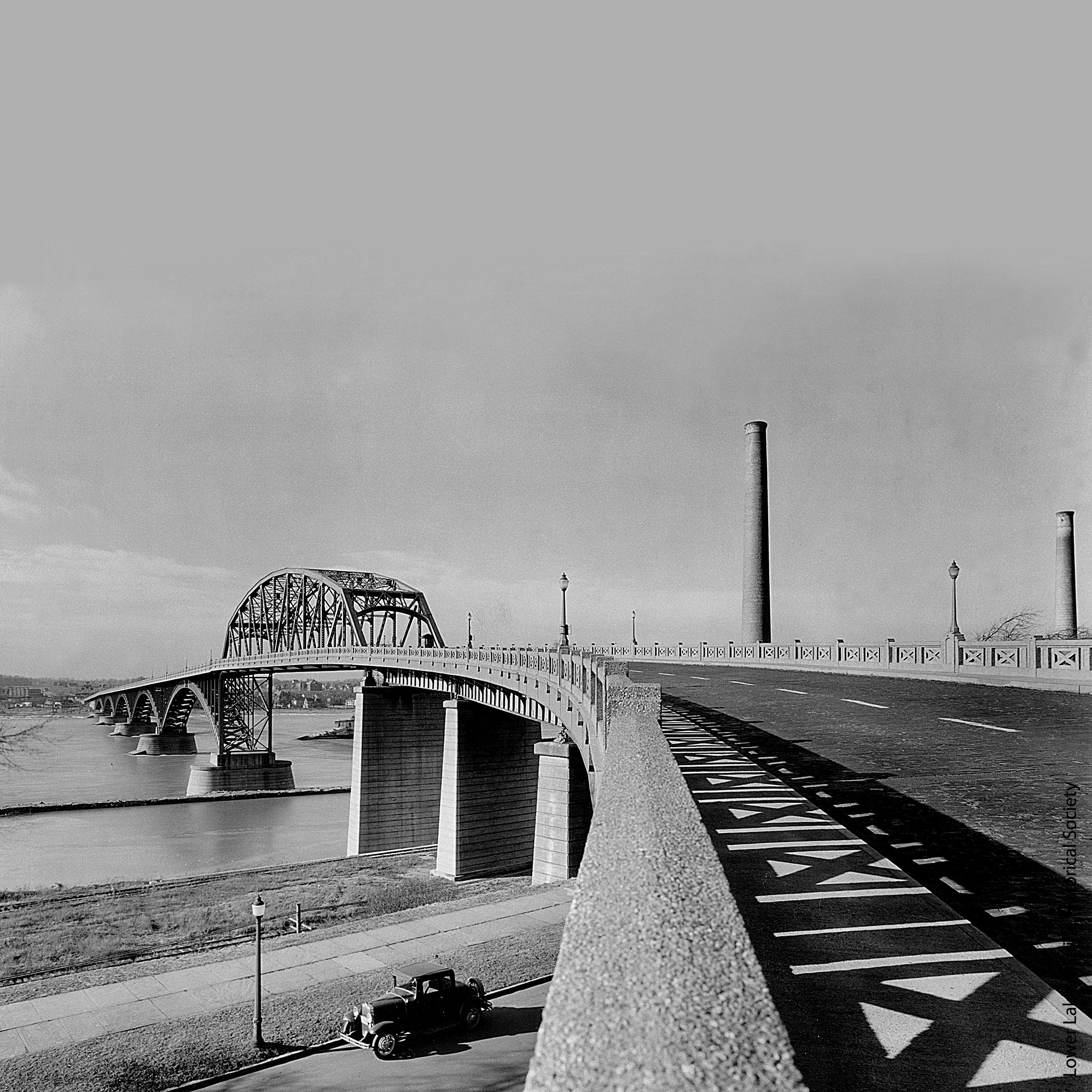 A road leads up to an arched bridge.