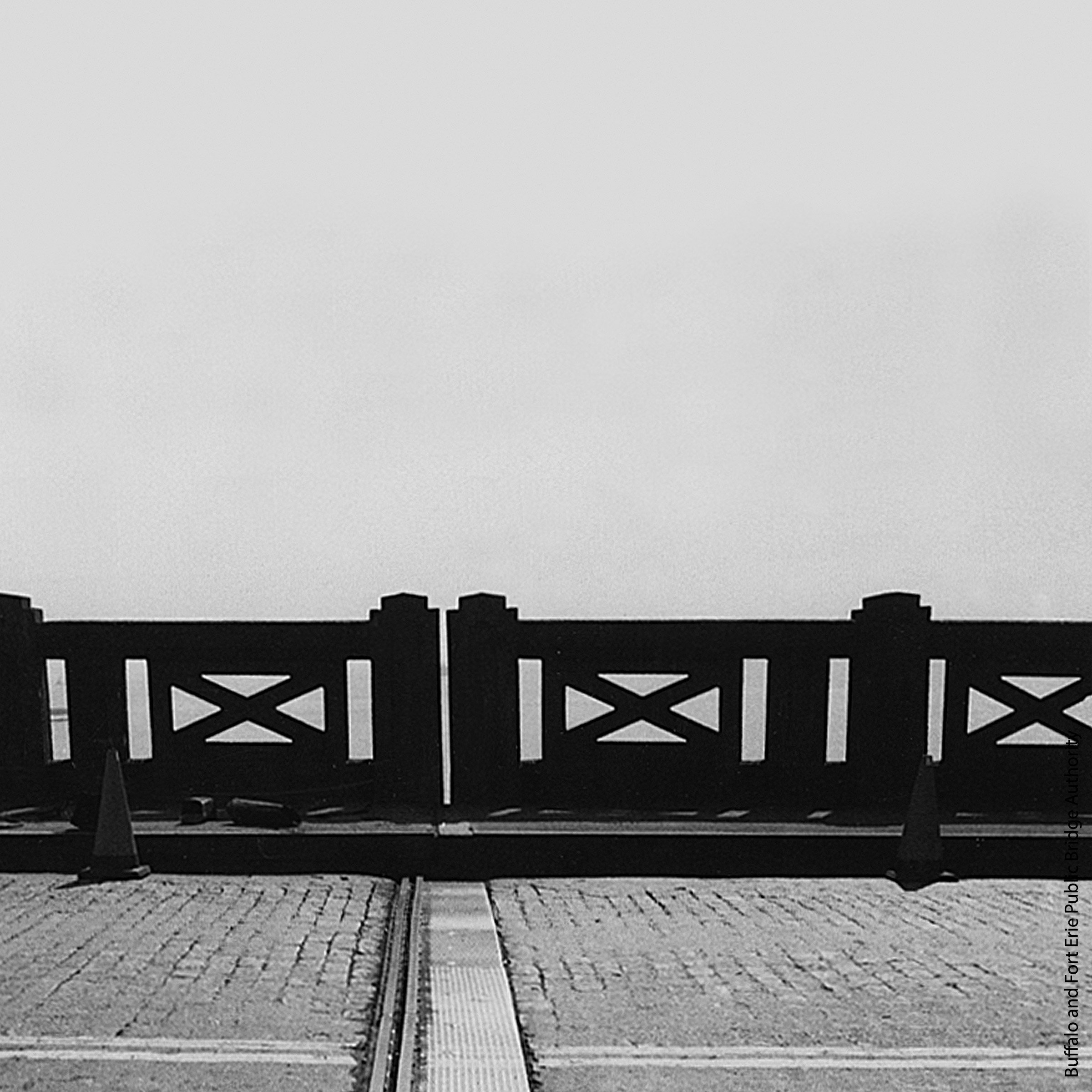 A concrete railing running along a road