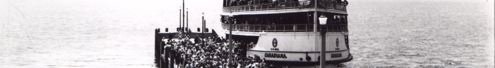 A large old boat docks with passengers