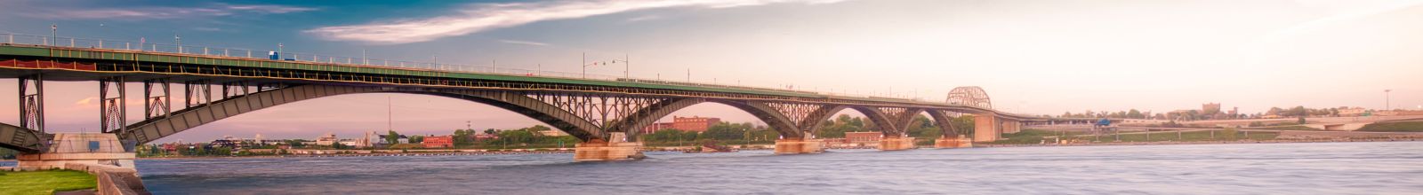 A large bridge crosses over a large river