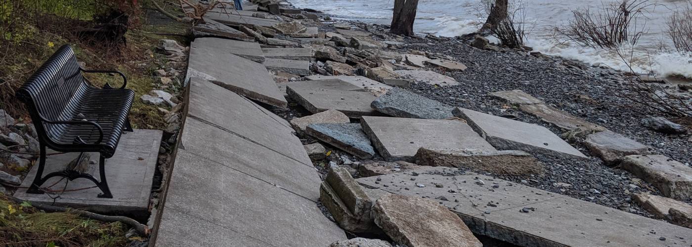 A walkway along water smashed from damage