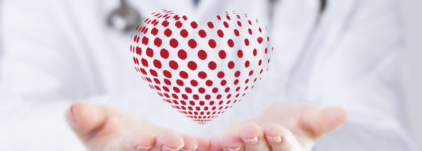 A Doctor holds a cartoon heart in their hands