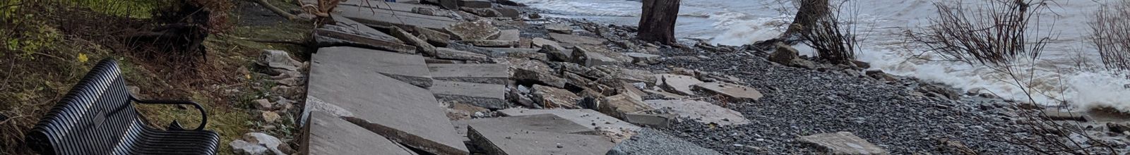 A walkway next to water smashed and broken