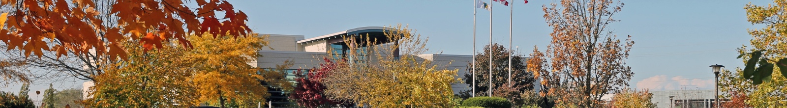 A large building with glass windows in the fall