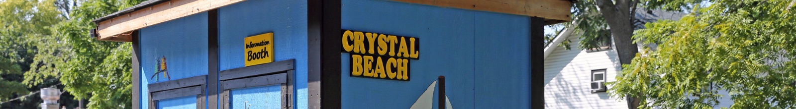 A small shack with a small sign that says Crystal Beach
