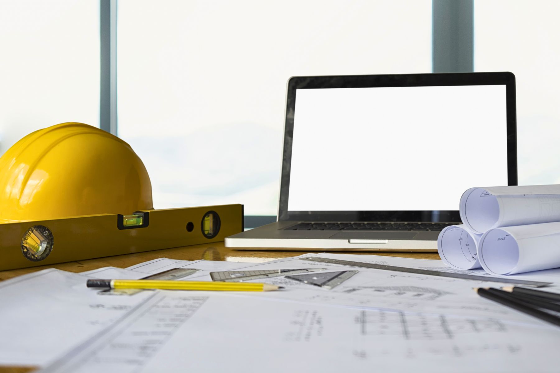 A hard hat and papers lay on a table