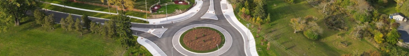 A road runs around a roundabout into four different streets
